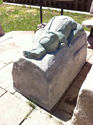 Dragon sleeping on a rock garden statue